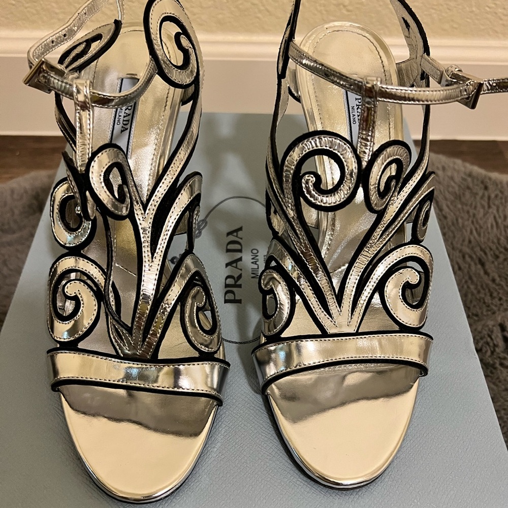 Prada silver designed sandals with fierce heel.